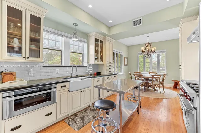a kitchen with stainless steel appliances granite countertop a stove a sink and a refrigerator