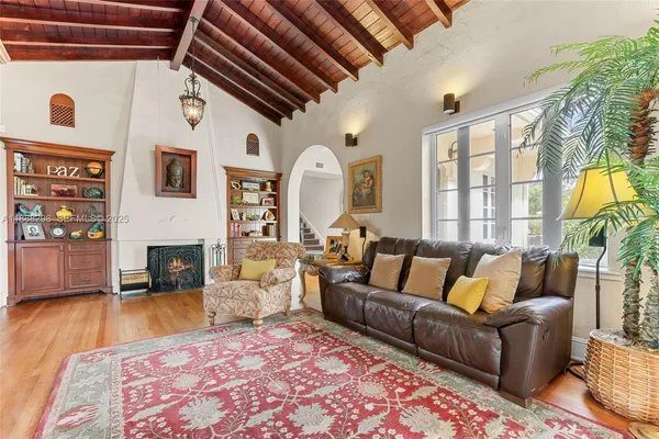 a living room with furniture fireplace and flat screen tv