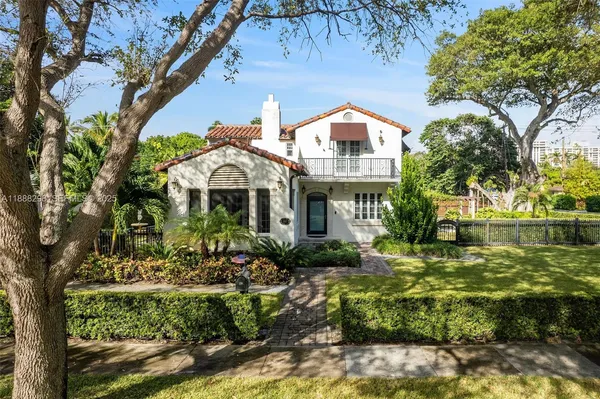 a front view of a house with a garden
