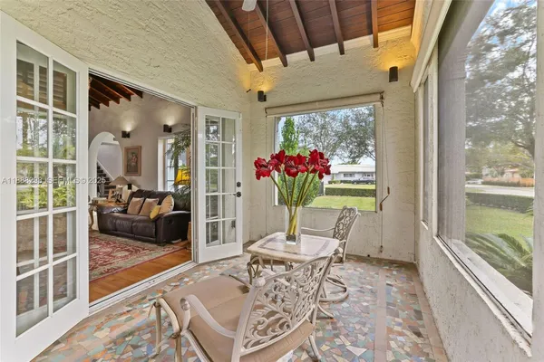 a living room with furniture and a floor to ceiling window
