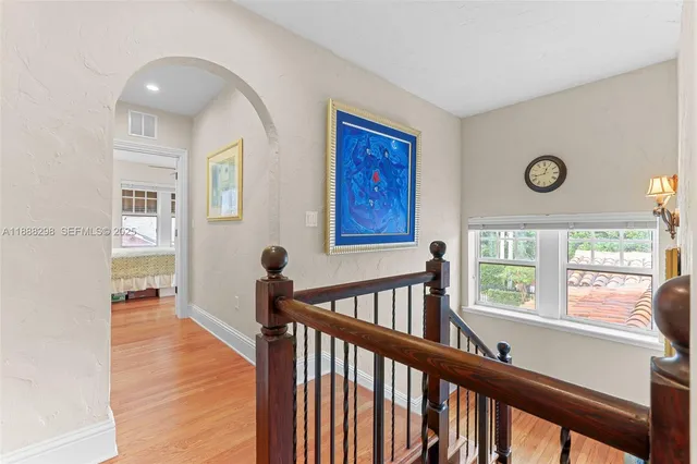 a view of entryway with wooden floor and windows