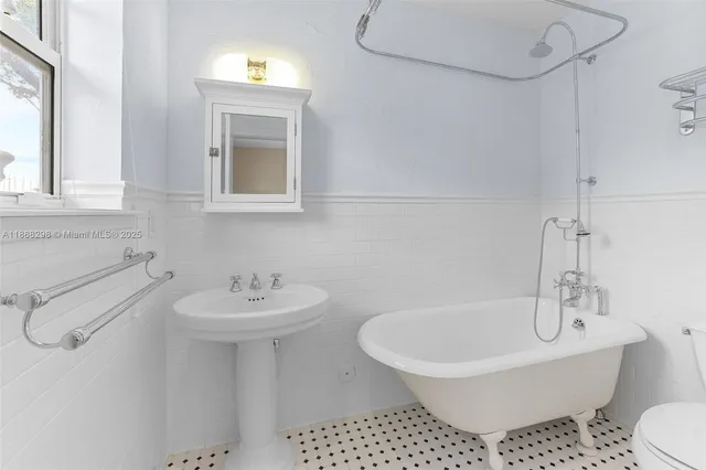 a bathroom with a sink a mirror and a toilet