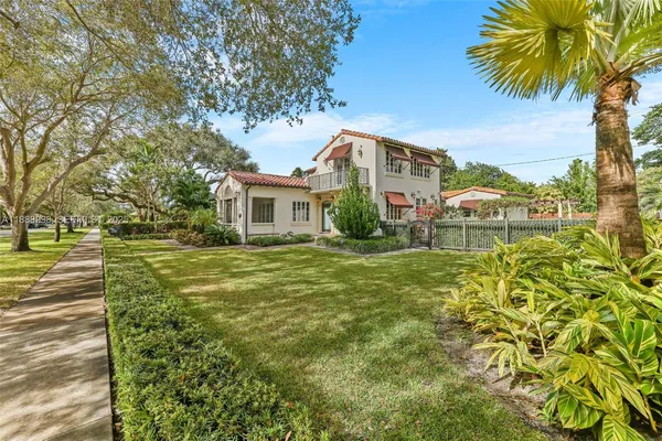 a front view of a house with a garden