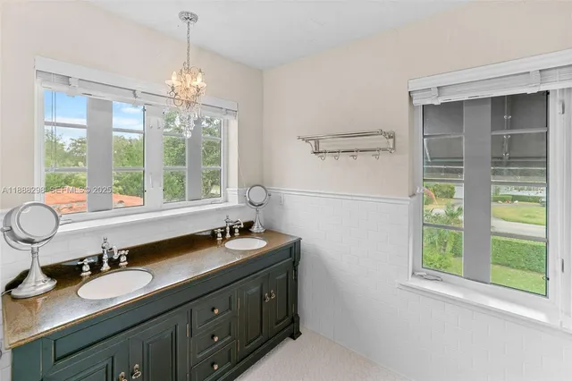 a bathroom with a sink double vanity and a mirror