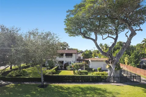a view of a house with swimming pool and a yard