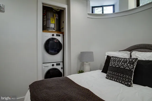 a bedroom with a bed and a view of balcony