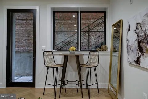 a view of a hallway with furniture and front door