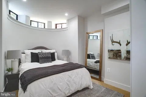 a bedroom with a large bed and view of bathroom