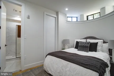 a bedroom with a bed and a walk in closet