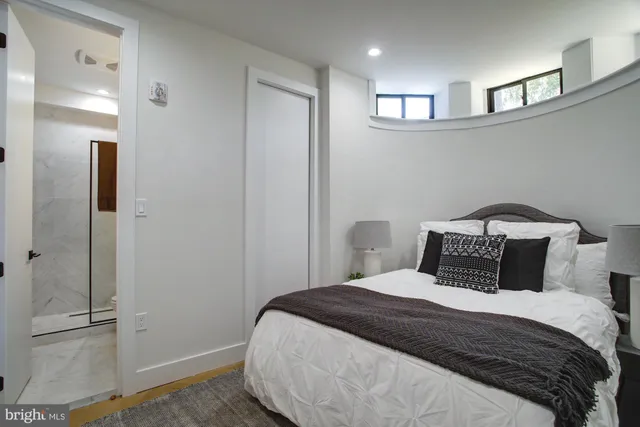 a bedroom with a bed and a walk in closet