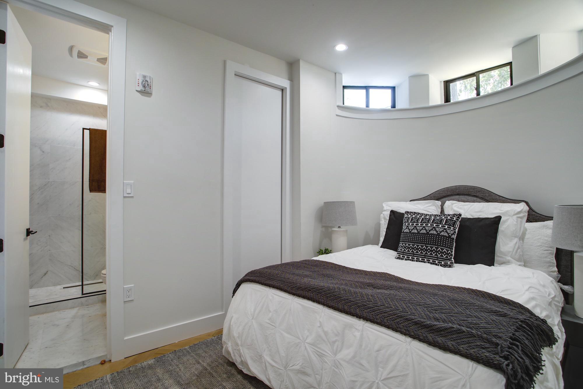 1225 11th Street Northwest, Unit A Washington, DC 20001 - Photo 10 of 18 a bedroom with a bed and a walk in closet