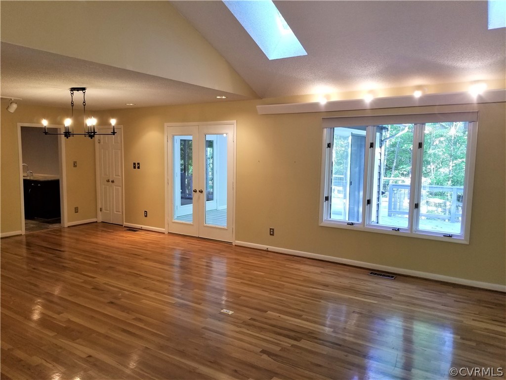 14301 Spring Gate Court Midlothian, VA 23112 - Photo 11 of 30 an empty room with wooden floor and windows