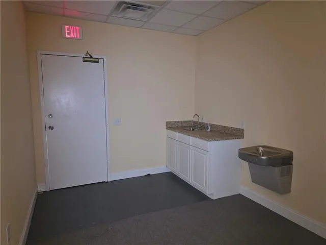 a utility room with sink dryer and washer