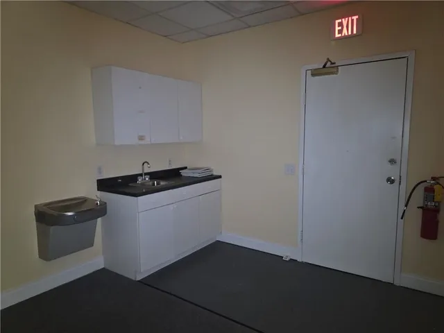 a bathroom with a granite countertop toilet and a mirror
