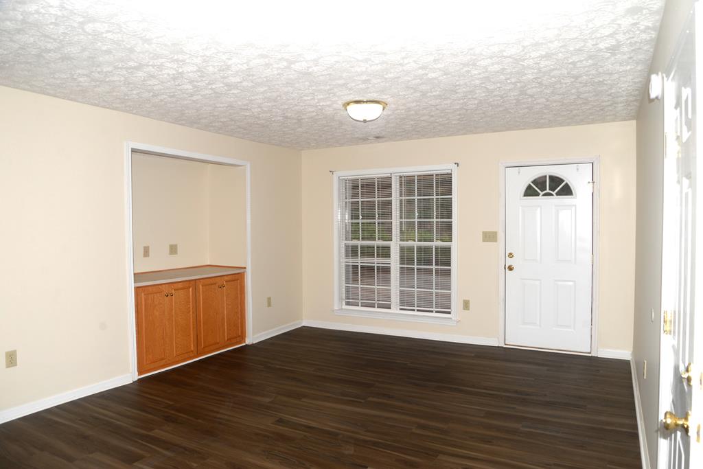 14 Kaitlyn Court Hamilton, GA 31811 - Photo 2 of 8 an empty room with wooden floor and windows