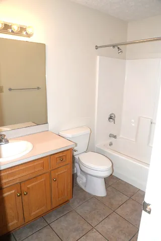 a bathroom with a toilet a sink and bathtub