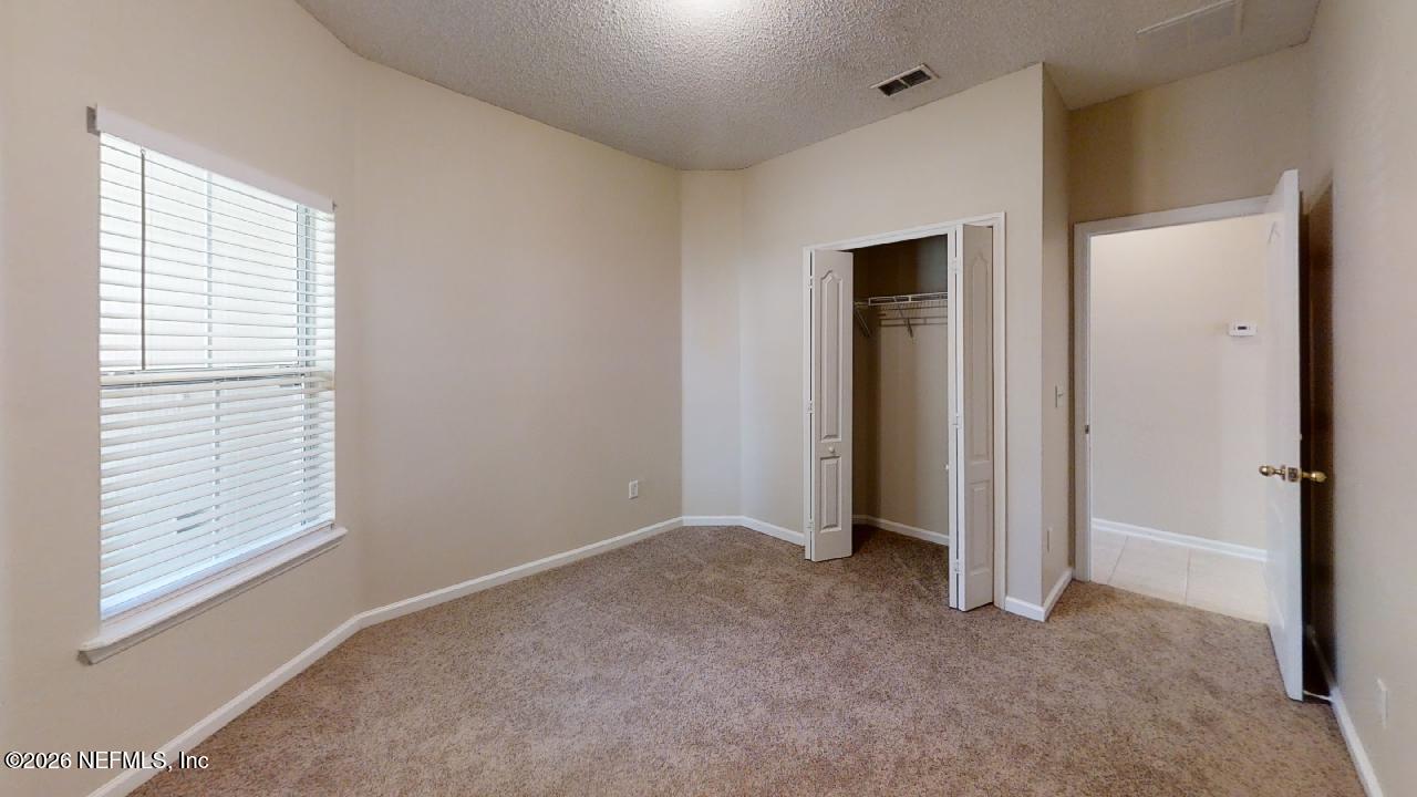 14454 Millhopper Road Jacksonville, FL 32258 - Photo 37 of 44 a view of an empty room with closet and a window