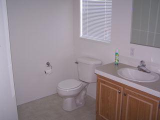 412 West Alpine Road Austin, TX 78704 - Photo 8 of 15 a bathroom with a granite countertop toilet a sink and a window