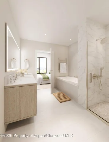 a spacious bathroom with a tub sink and mirror
