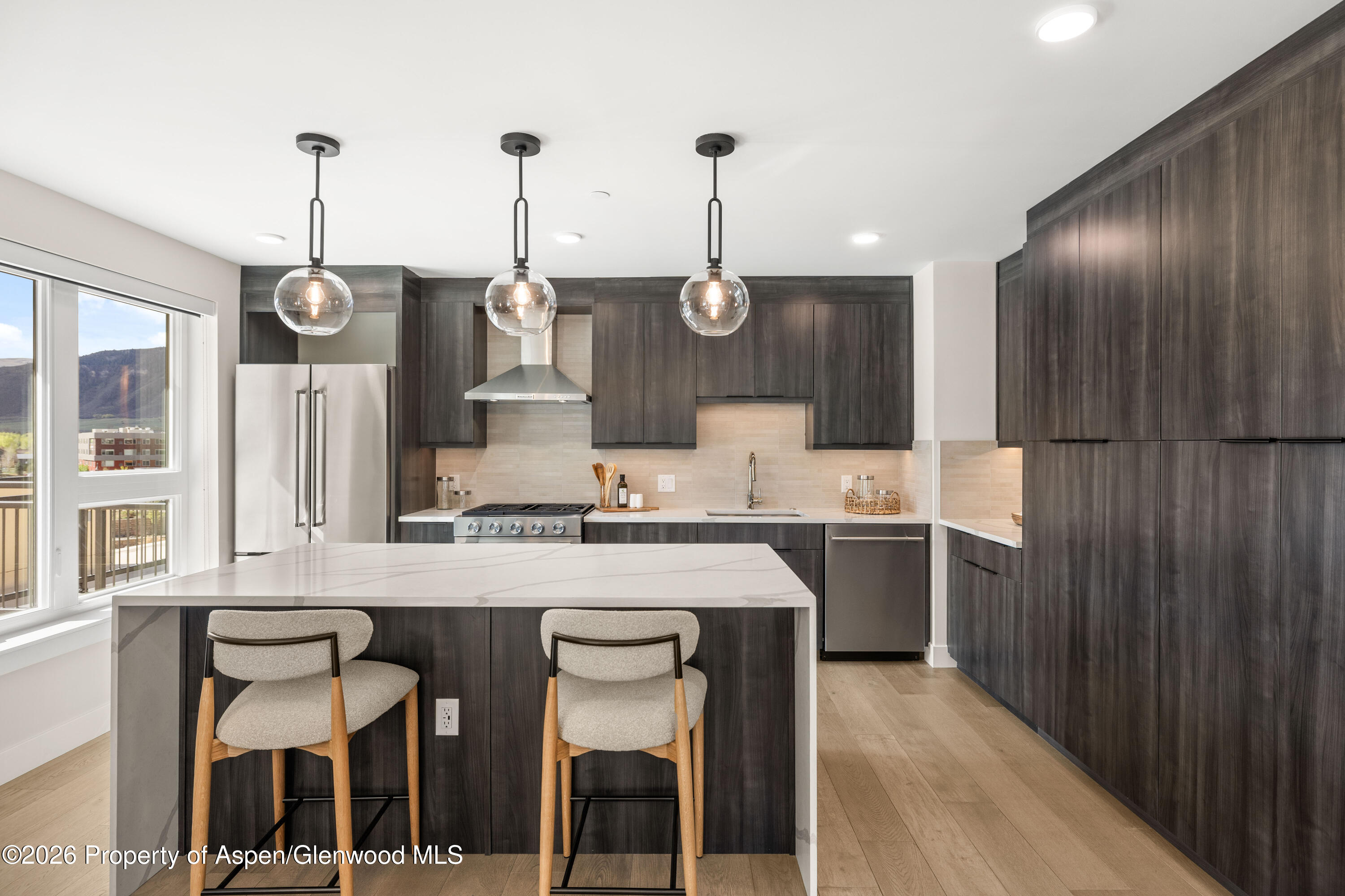 85 Kodiak Drive, Unit 304 Basalt, CO 81621 - Photo 6 of 21 a kitchen with stainless steel appliances kitchen island granite countertop a stove a sink and a refrigerator