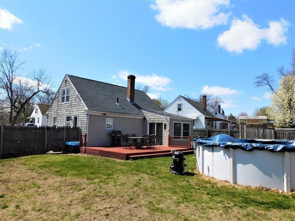94 Surrey Road Springfield, MA 01118 - Photo 11 of 36 a front view of a house with a yard table and chairs