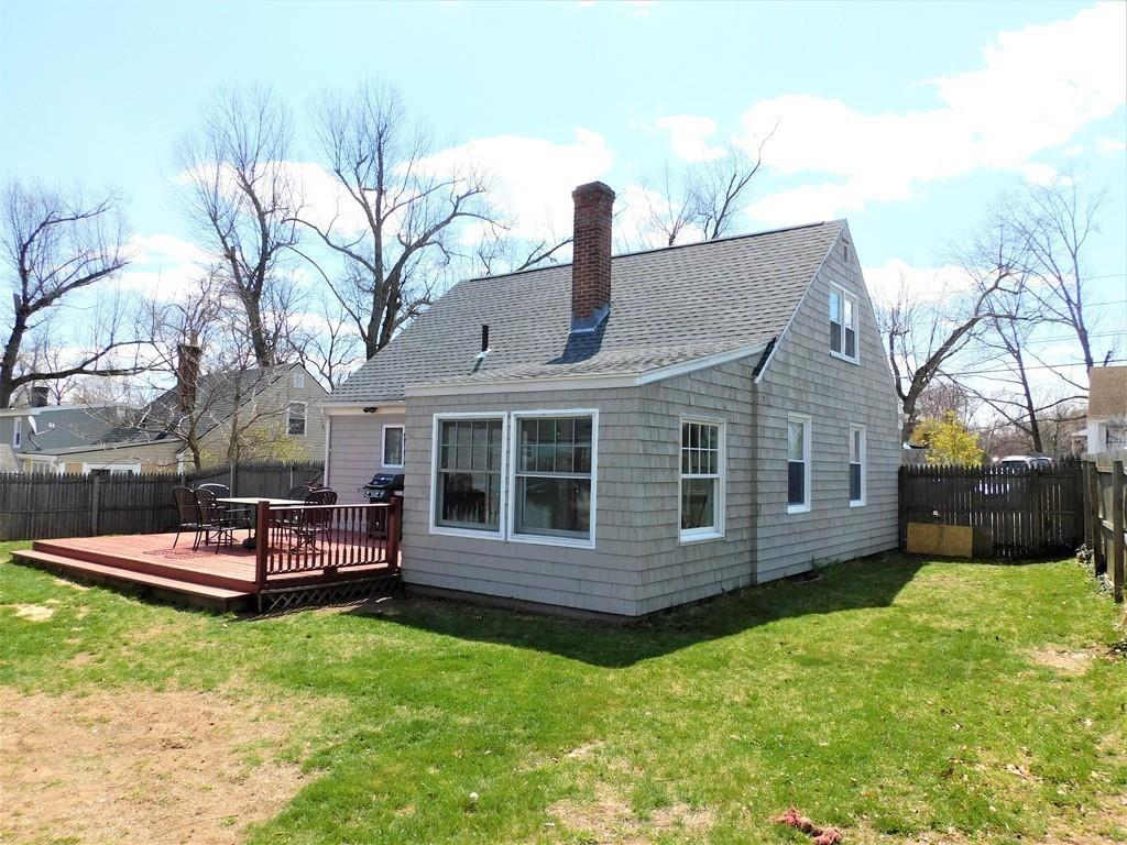94 Surrey Road Springfield, MA 01118 - Photo 10 of 36 a view of a house with a yard chairs and a fire pit