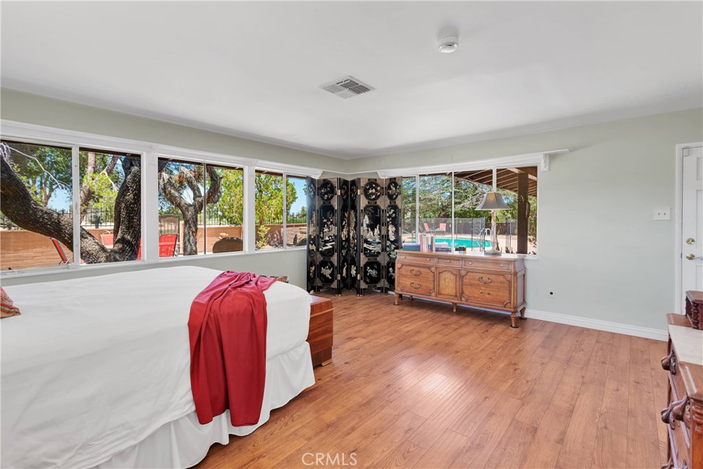 19955 Chickasaw Road Apple Valley, CA 92307 - Photo 25 of 60 a bed room with a bed and a large window