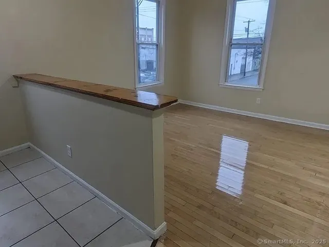 a room with wooden floor and windows