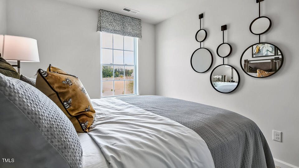 5215 Red Crimson Drive Willow Spring, NC 27592 - Photo 21 of 29 a bedroom with a bed and a window