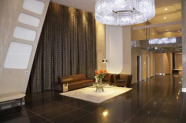a view of a dining room with furniture and chandelier