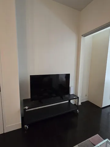 a living room with a black white wall and a fireplace