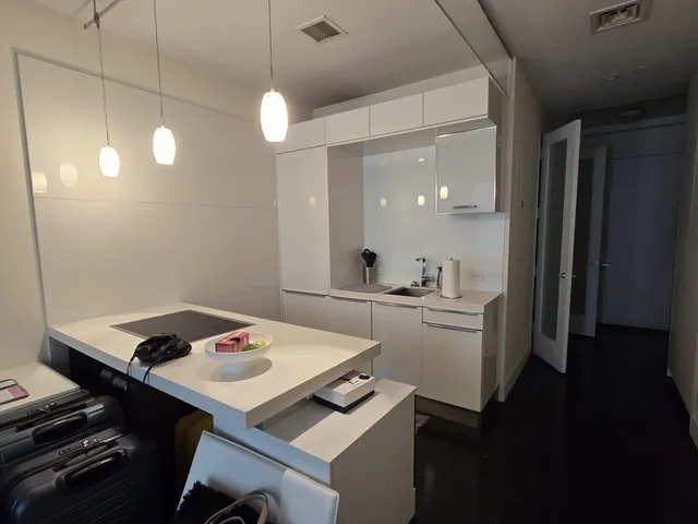 a kitchen with a sink a stove and chairs