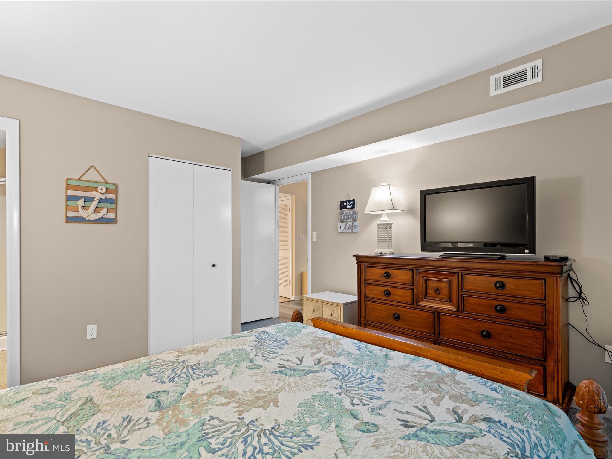 39346 Racquet Lane, Unit 8504 Bethany Beach, DE 19930 - Photo 27 of 40 a bedroom with a bed and a flat screen tv