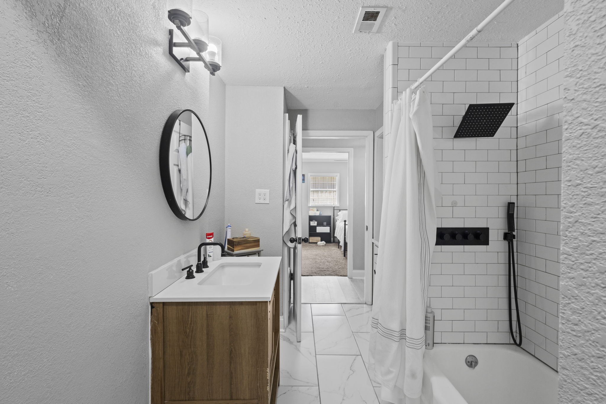 1006 Montgomery Street Port Neches, TX 77651 - Photo 15 of 29 a bathroom with a sink a mirror and shower