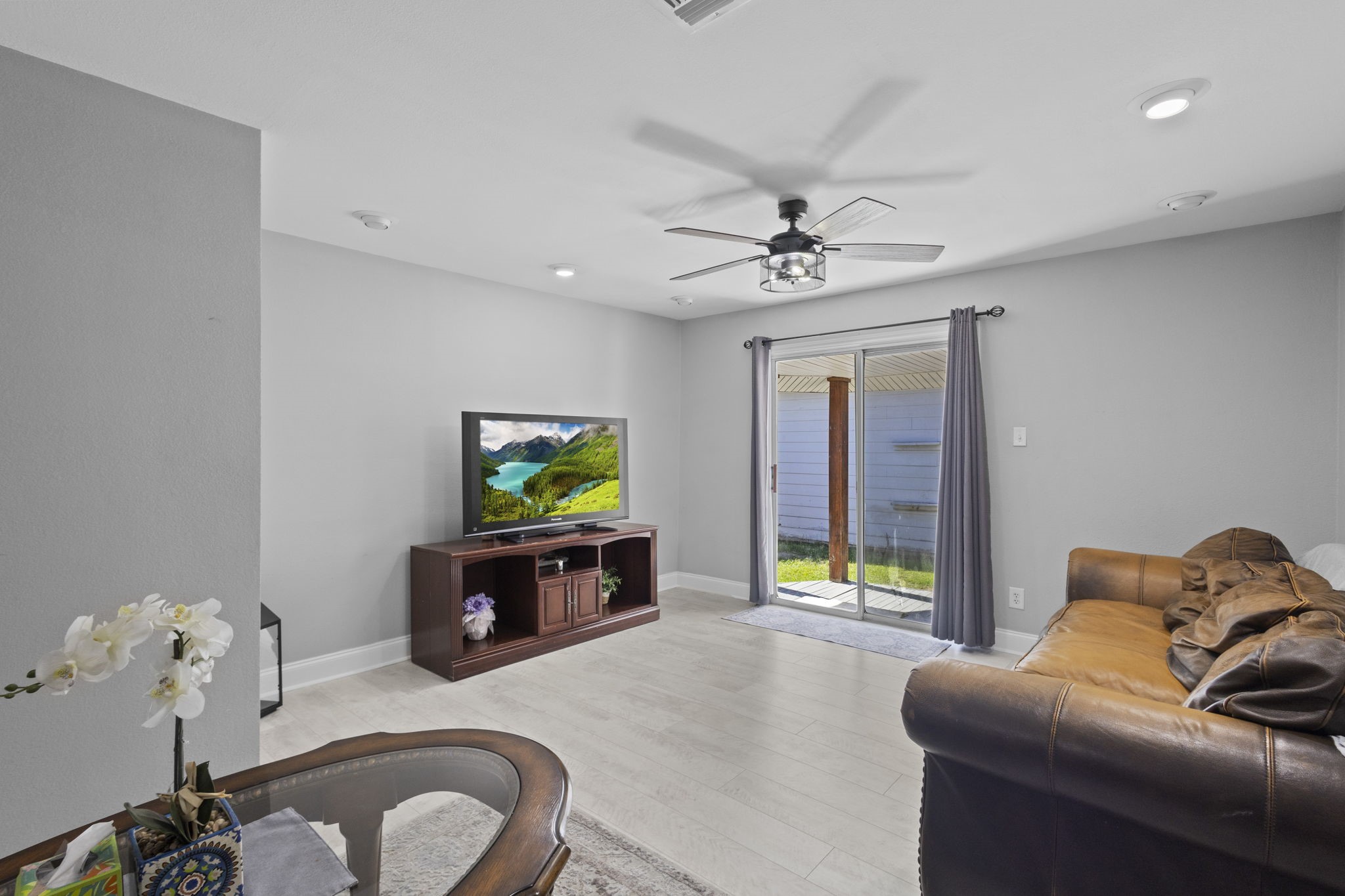1006 Montgomery Street Port Neches, TX 77651 - Photo 19 of 29 a living room with furniture a flat screen tv and a fireplace