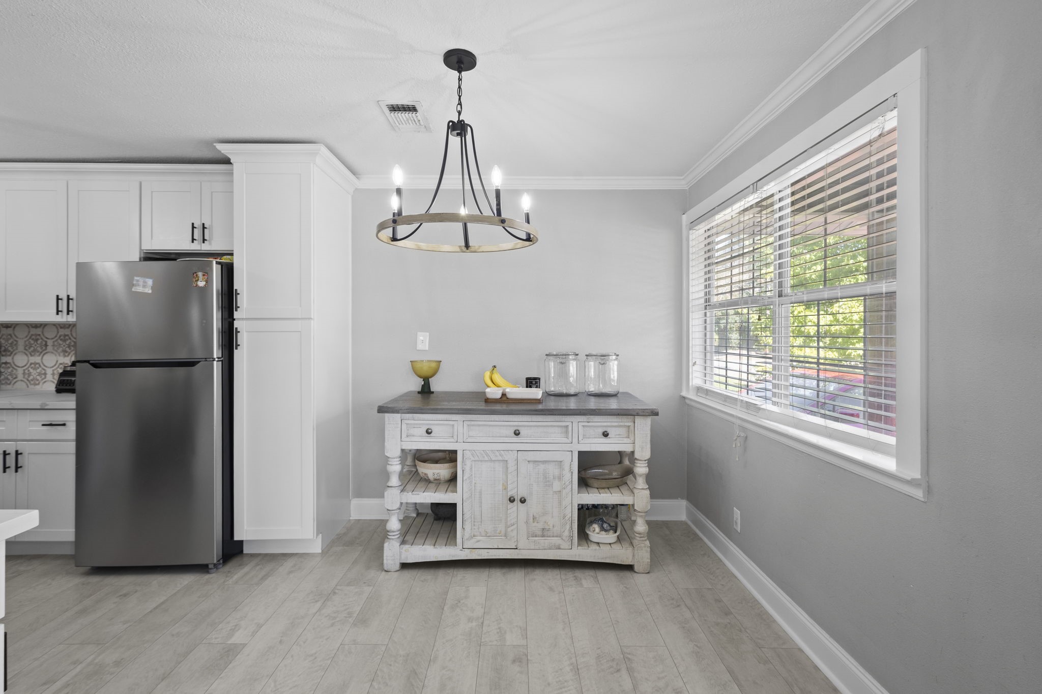 1006 Montgomery Street Port Neches, TX 77651 - Photo 4 of 29 a view of a kitchen with a window a refrigerator and wooden floor