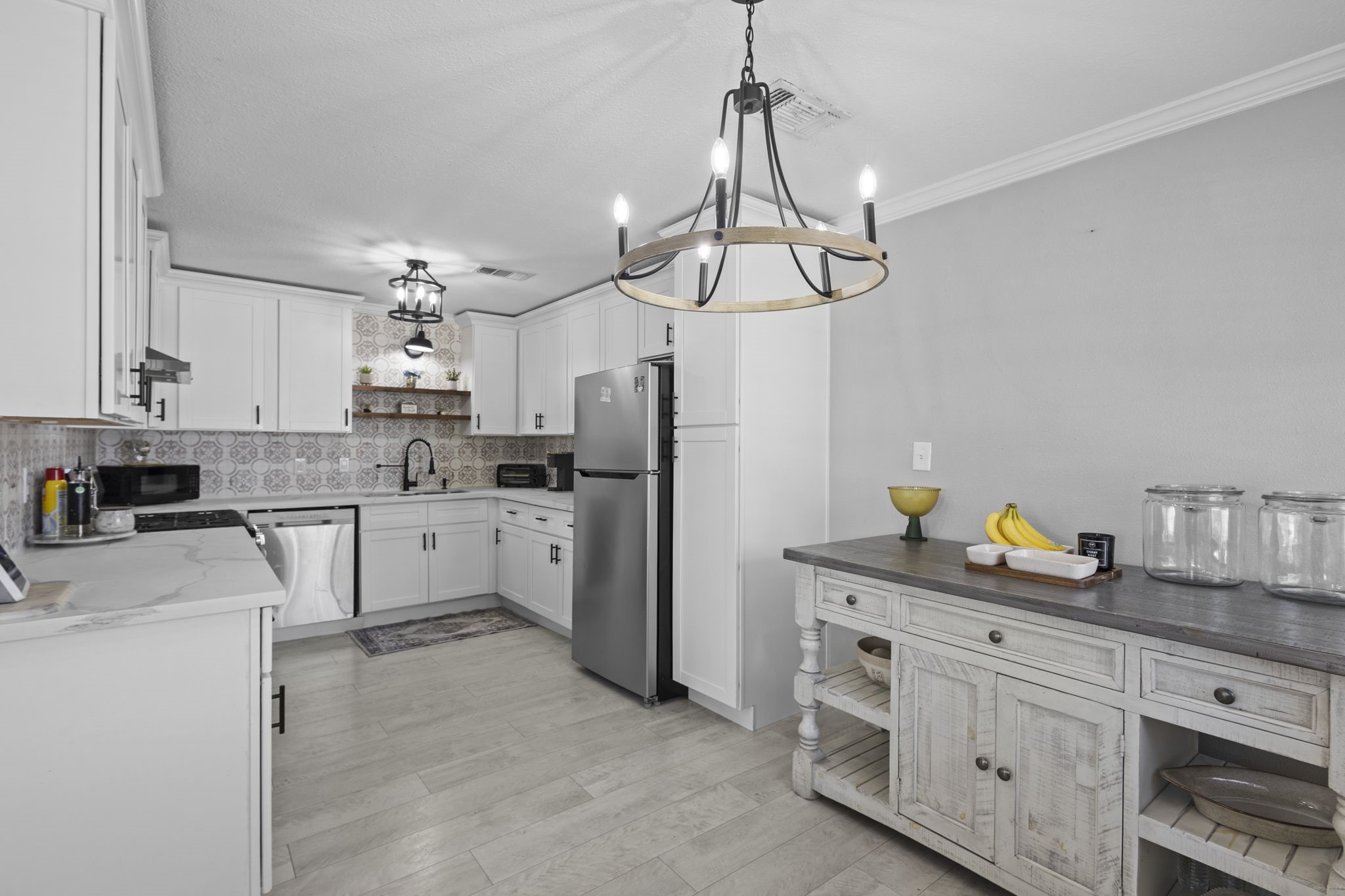 1006 Montgomery Street Port Neches, TX 77651 - Photo 5 of 29 a kitchen with white cabinets and stainless steel appliances
