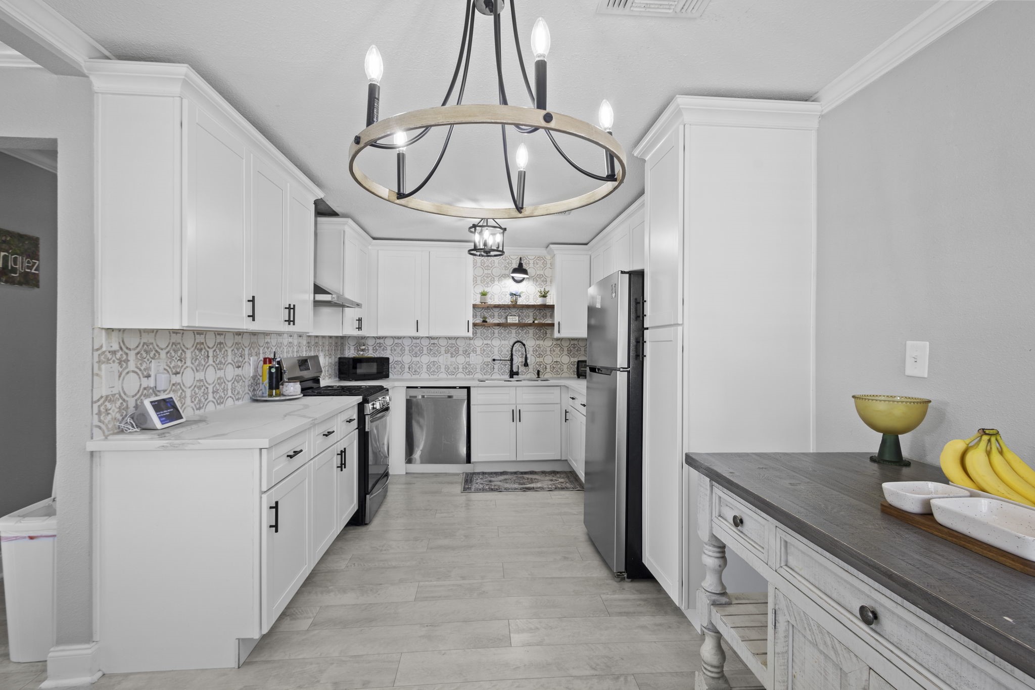 1006 Montgomery Street Port Neches, TX 77651 - Photo 6 of 29 a kitchen with stainless steel appliances white cabinets a sink a stove a refrigerator and island