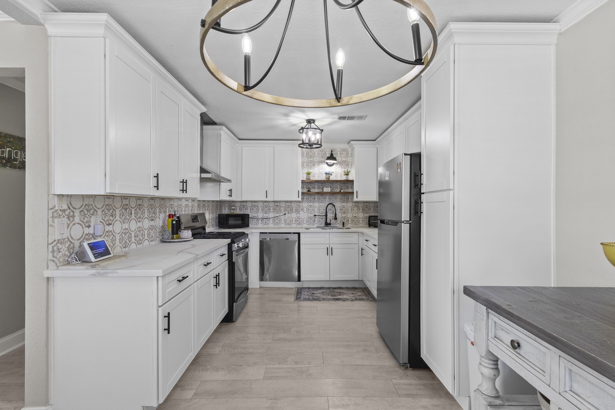 1006 Montgomery Street Port Neches, TX 77651 - Photo 7 of 29 a kitchen with stainless steel appliances granite countertop a cabinets and a stove top oven