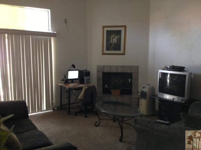 45784 Sutter Creek Road Indio, CA 92201 - Photo 3 of 3 a living room with furniture a fireplace and a window