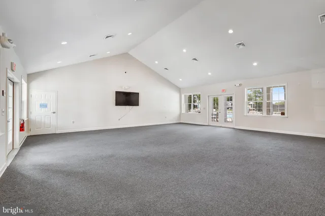 a view of empty room with a kitchen and a fireplace