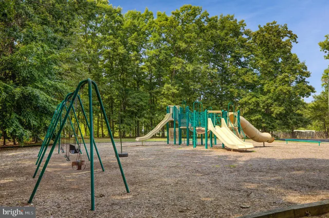 a view of outdoor space with playground and green space