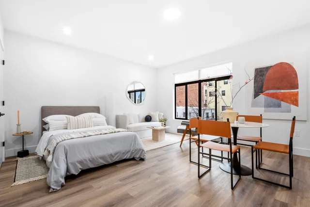 a bedroom with a bed and window