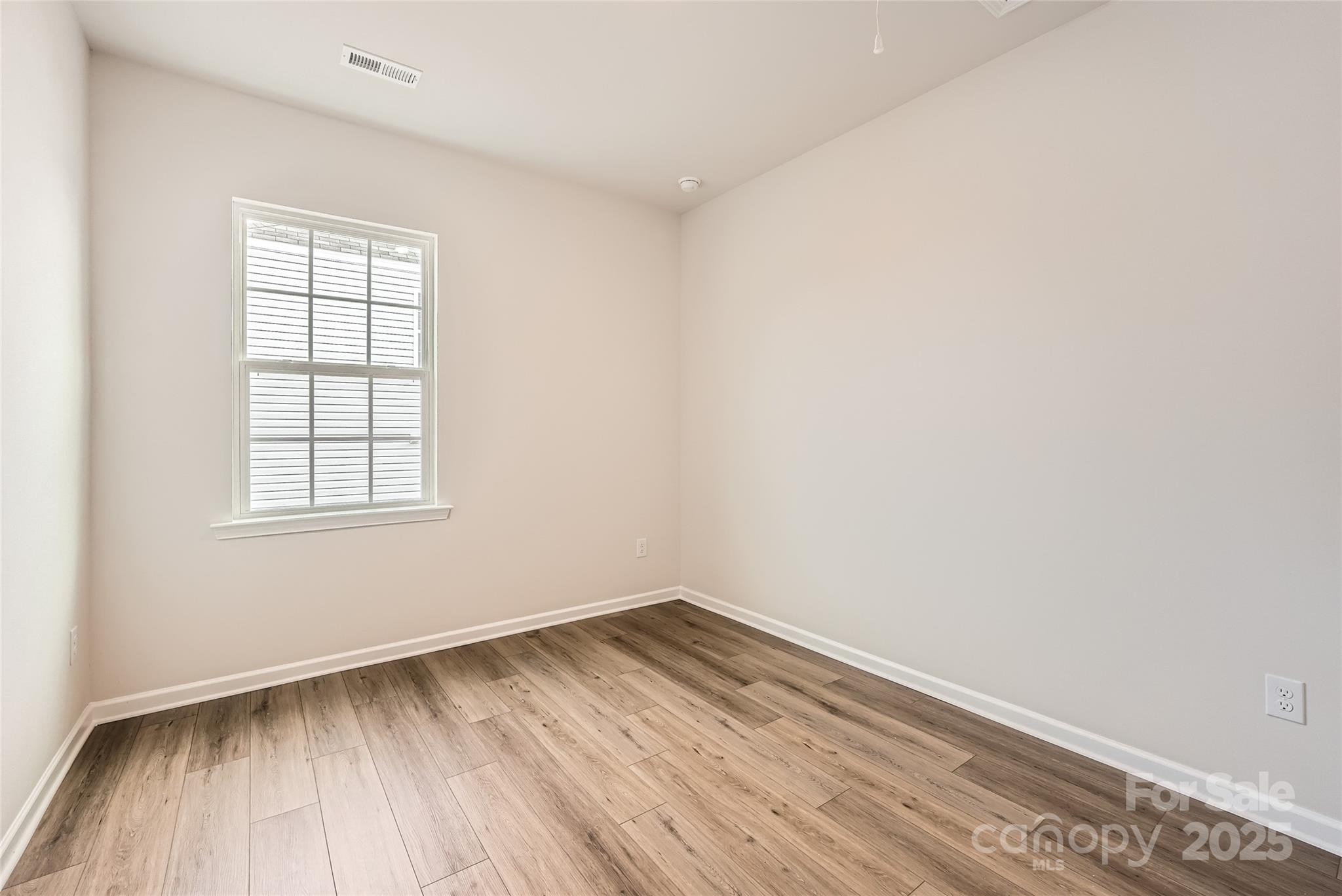 4469 Doyle Rdg Road Maiden, NC 28650 - Photo 12 of 14 an empty room with wooden floor and windows