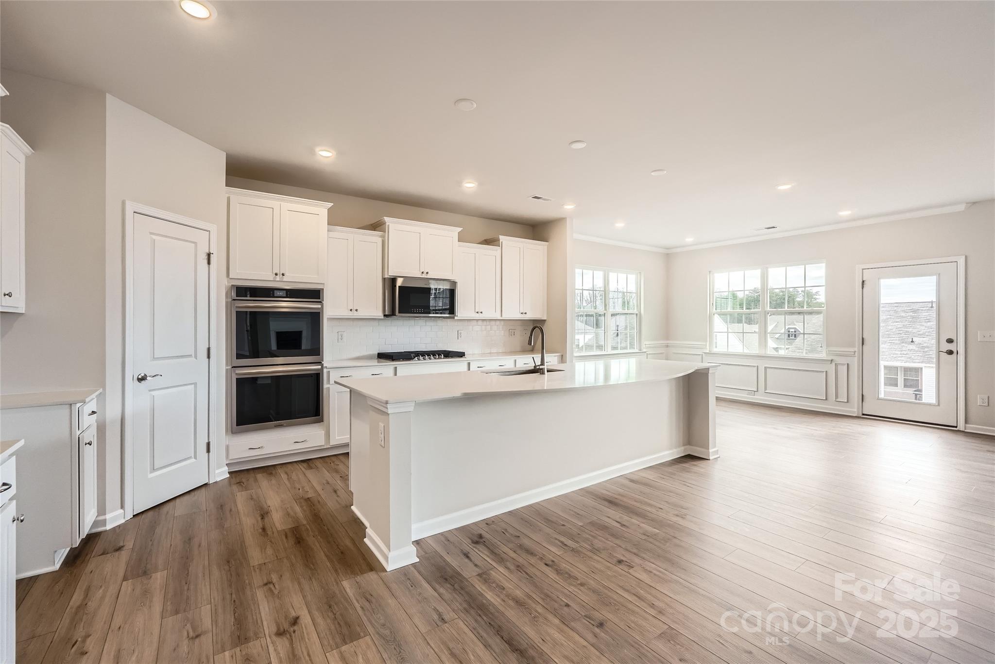 4469 Doyle Rdg Road Maiden, NC 28650 - Photo 4 of 14 a large kitchen with stainless steel appliances wooden floors and wooden cabinets