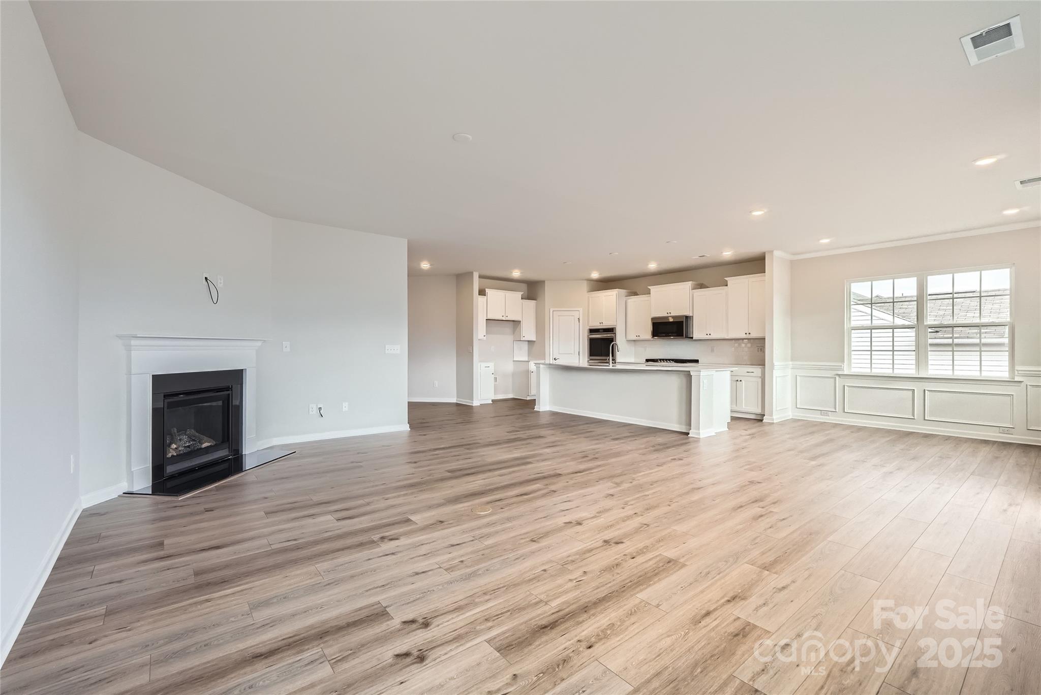 4469 Doyle Rdg Road Maiden, NC 28650 - Photo 5 of 14 a view of empty room with wooden floor and fireplace