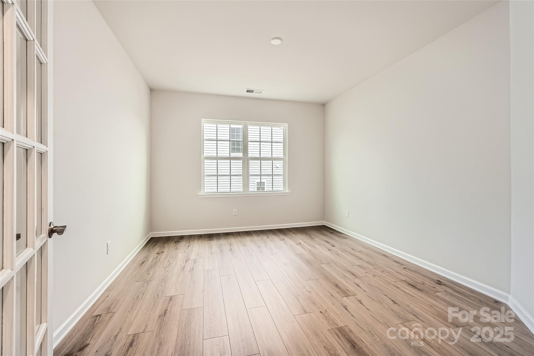 4469 Doyle Rdg Road Maiden, NC 28650 - Photo 6 of 14 an empty room with wooden floor and windows