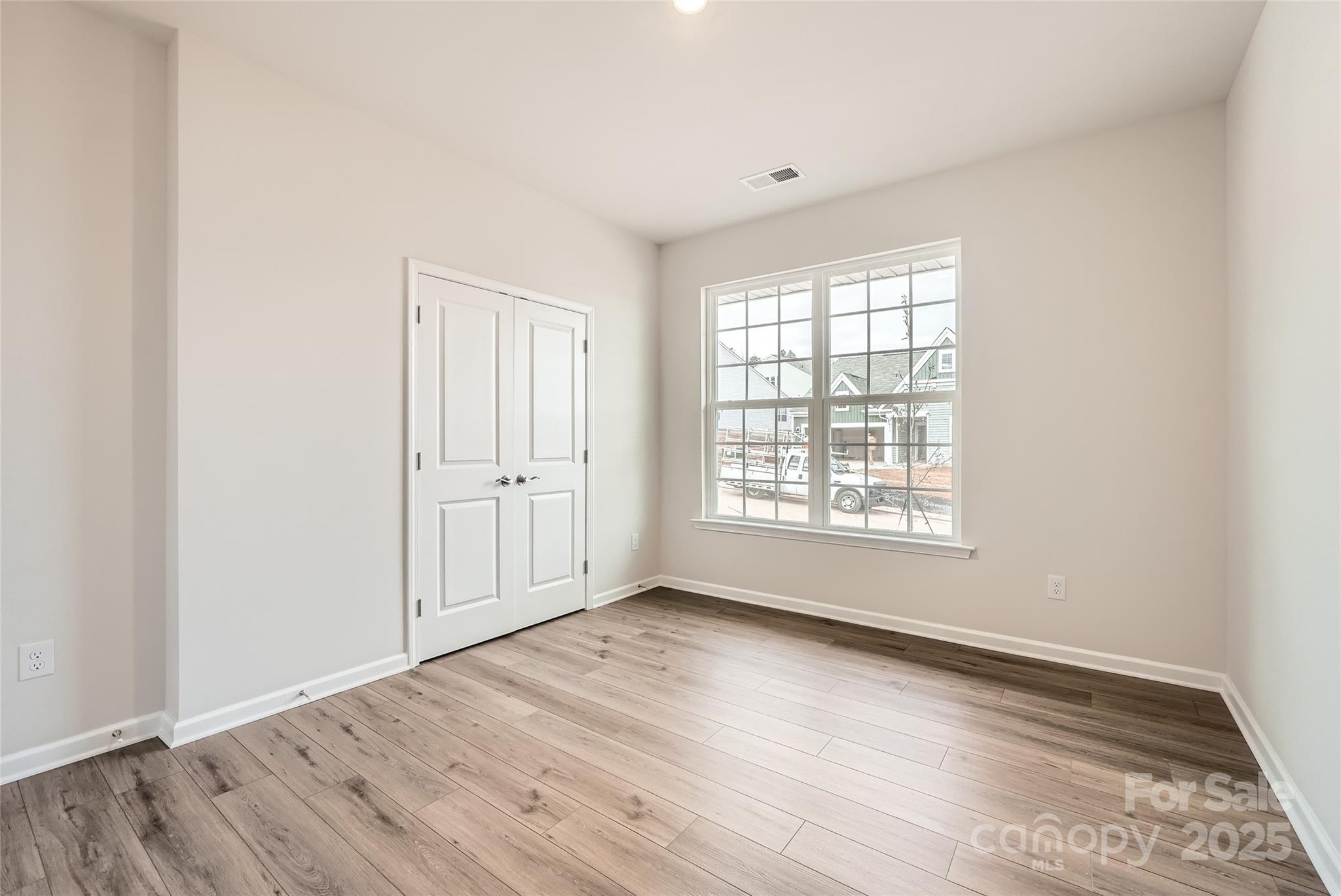 4469 Doyle Rdg Road Maiden, NC 28650 - Photo 10 of 14 an empty room with wooden floor and windows
