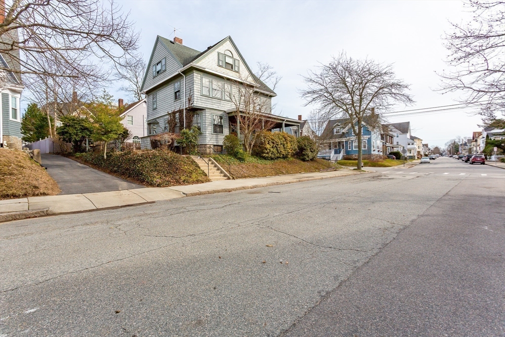 445 Madison Street Fall River, MA 02720 - Photo 3 of 42 a front view of a house with a yard and garage