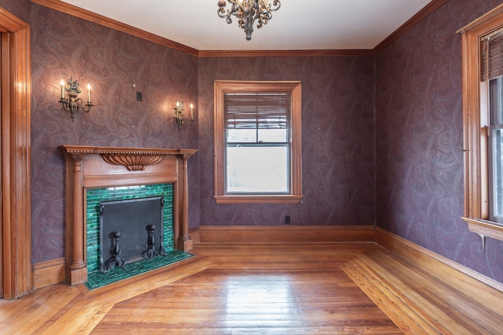 445 Madison Street Fall River, MA 02720 - Photo 7 of 42 a view of an empty room with wooden floor and a window